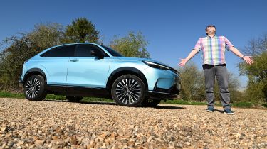 Auto Express web producer Pete Baiden standing next to the Honda e:Ny1